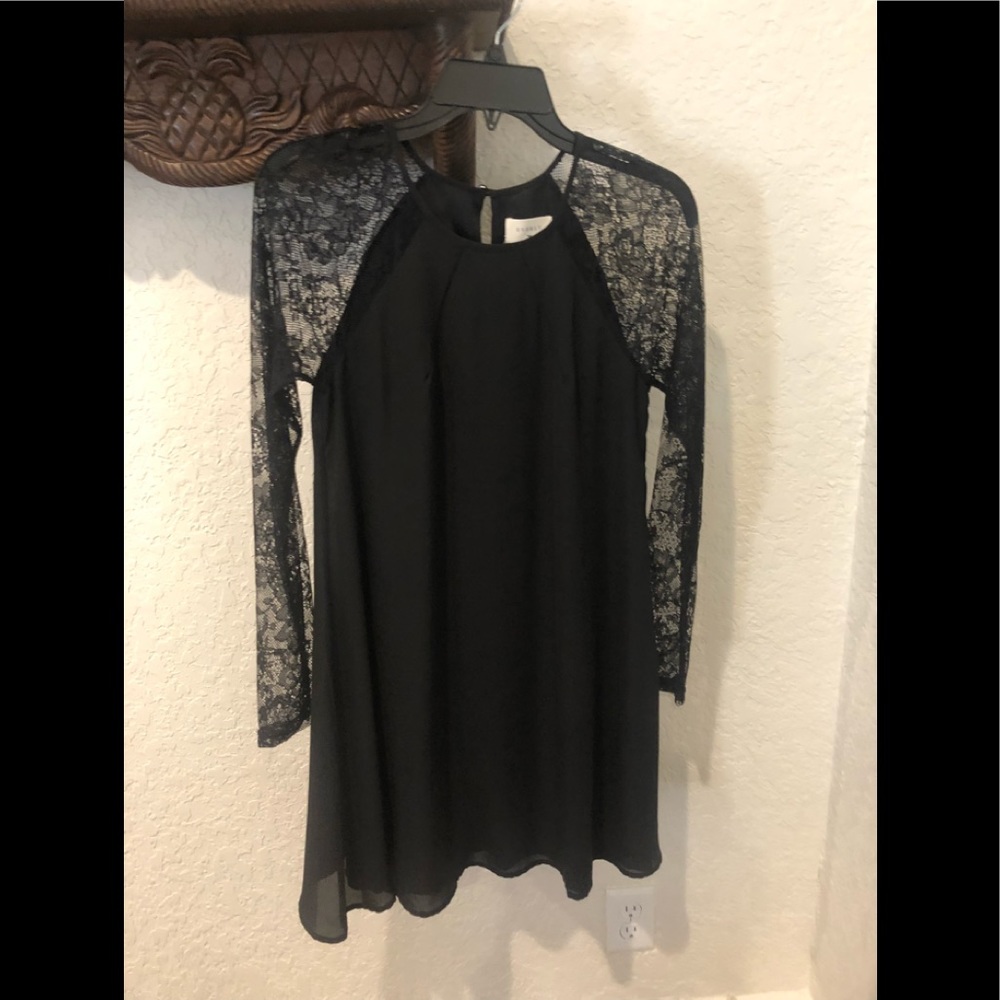 NWT black dress with sheer lace sleeves.